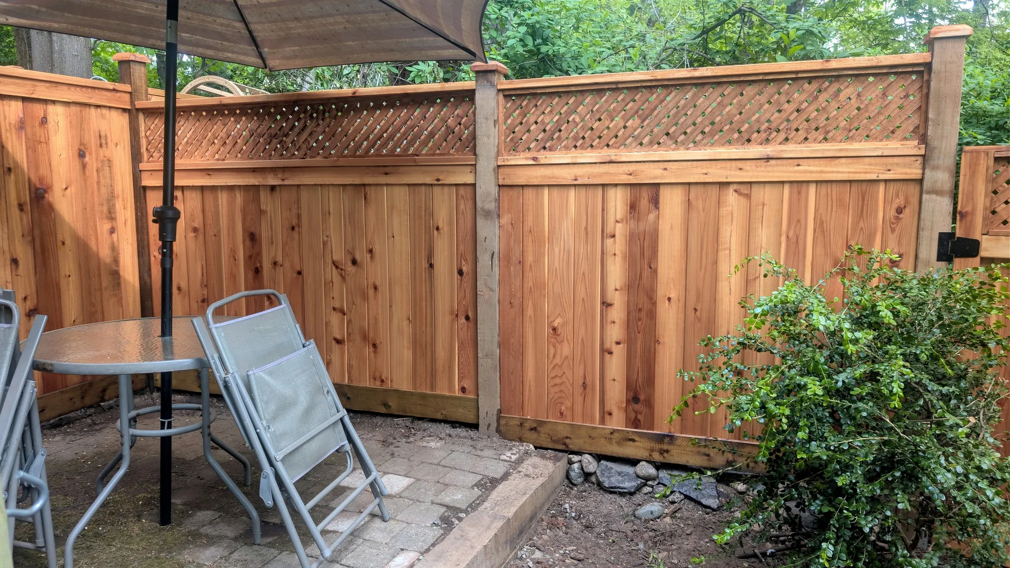 Cedar privacy fence with a lattice top beside a patio, Champlain Heights, Vancouver